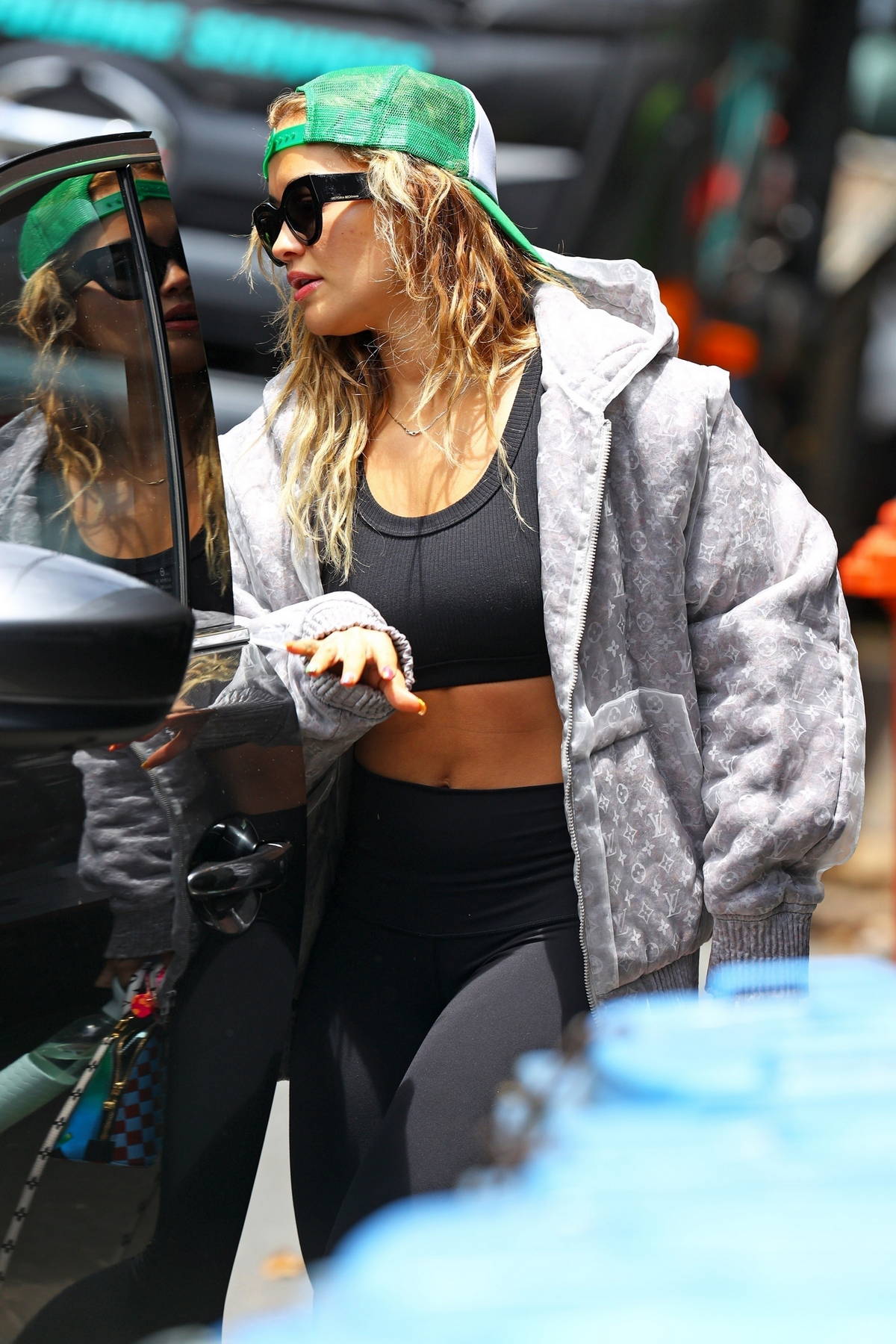 rita ora rocks a louis vuitton hoodie with black crop top and