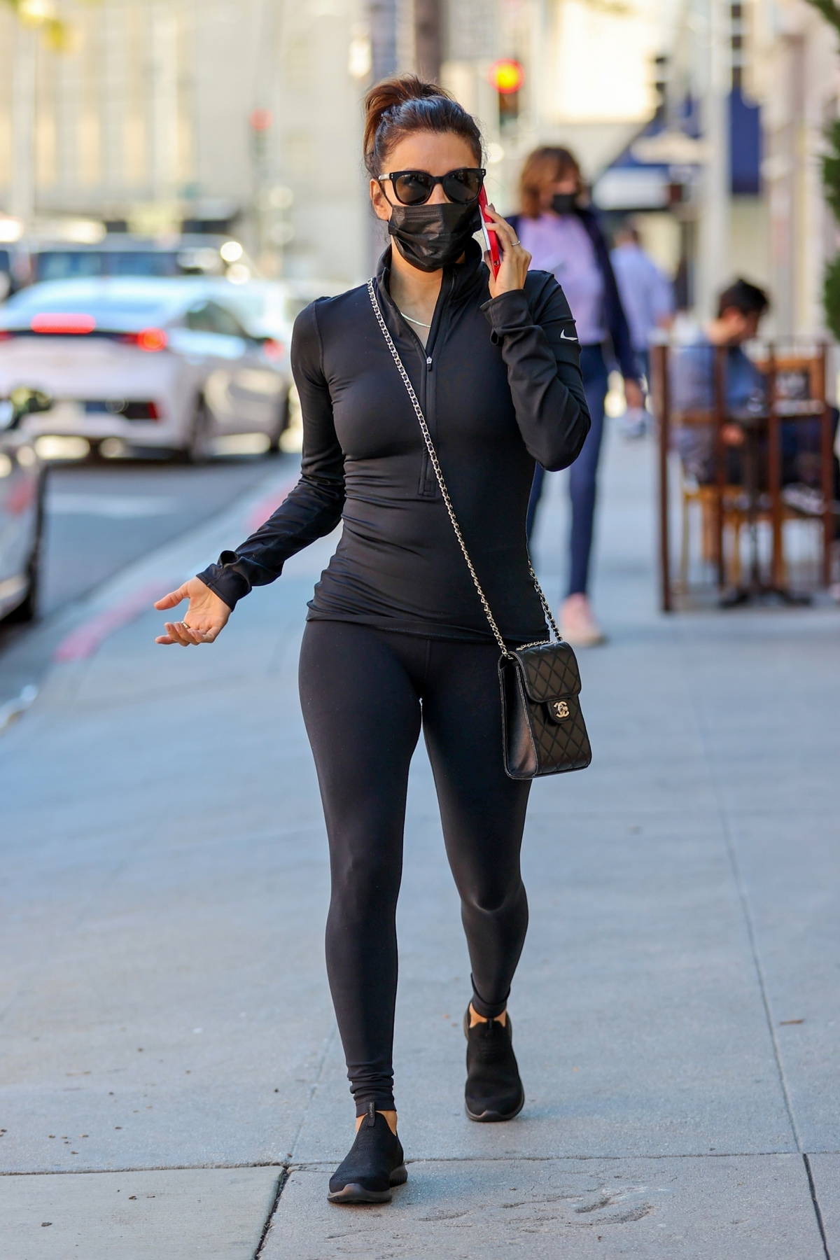 Eva Longoria sports a form-fitting black top with leggings while