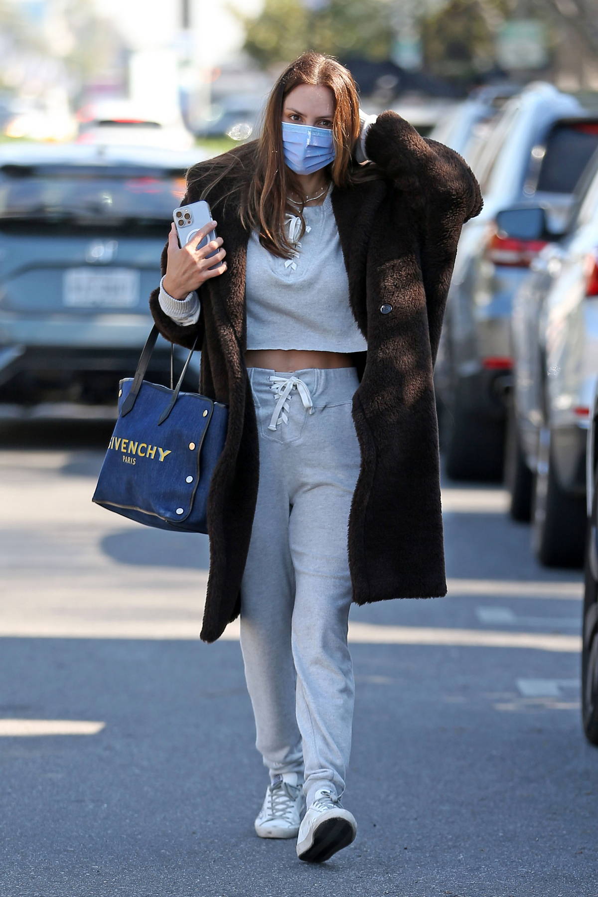 Alessandra Ambrosio sports a crop top and flared leggings while