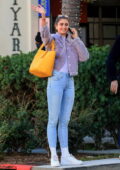Taylor Hill dons a purple teddy jacket and skin-tight jeans as she joins a few friends for lunch in Beverly Hills, California