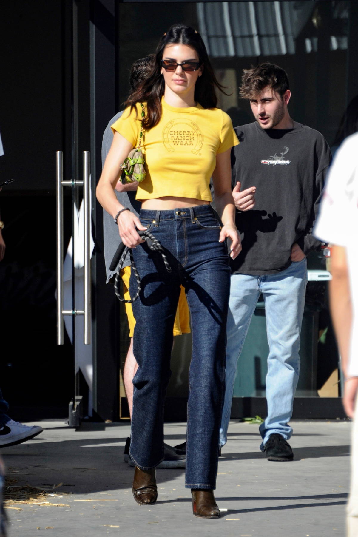 Kendall Jenner looks cute in a yellow crop top and jeans while