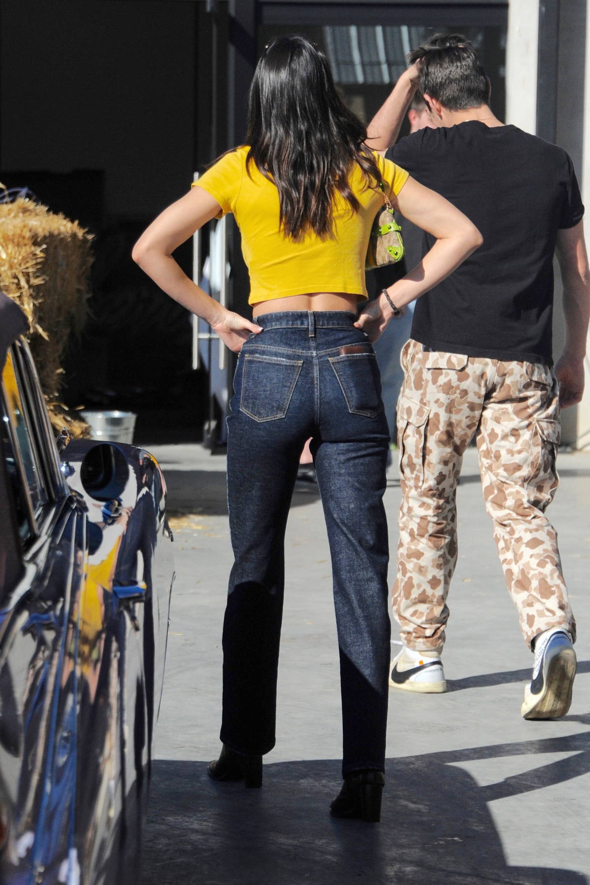 Kendall Jenner looks cute in a yellow crop top and jeans while spotted on  the set