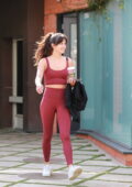 Sarah Hyland wears a white sports bra with an oversized shirt and leggings  while leaving a