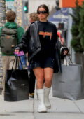 Addison Rae rocks an oversized t-shirt with leather jacket and white boots during a shopping trip in Beverly Hills, California