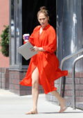 Jennifer Lopez shows some legs in an orange button-up dress while out for a business meeting in Los Angeles