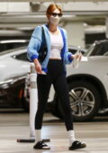 Kendall Jenner wears a knitted blue cardigan with a white top and