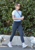 Lucy Hale wears a white tee and dark grey leggings for her daily hike with her dogs in Los Angeles