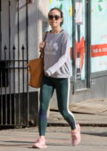 Olivia Wilde sports an Adidas sweatshirt and green leggings while out for some shopping in London, UK