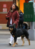 Emily Ratajkowski wears a red denim jacket over white sweats while on a stroll with her dog in New York City