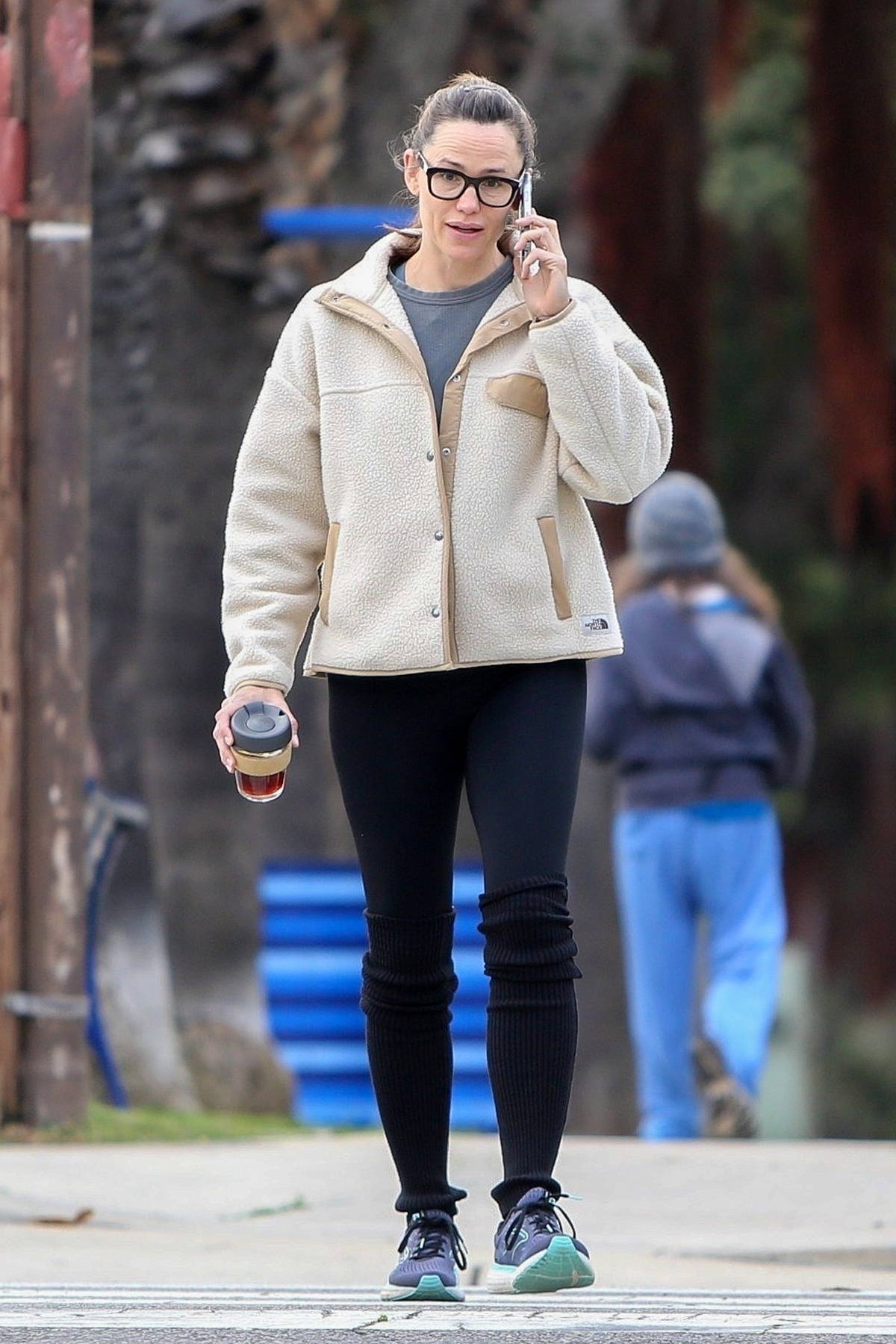 Jennifer Garner wears a teddy jacket with leggings and leg warmers while  out on a walk