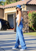 Josephine Skriver looks fab in a white corset top and denim overalls while  heading out during