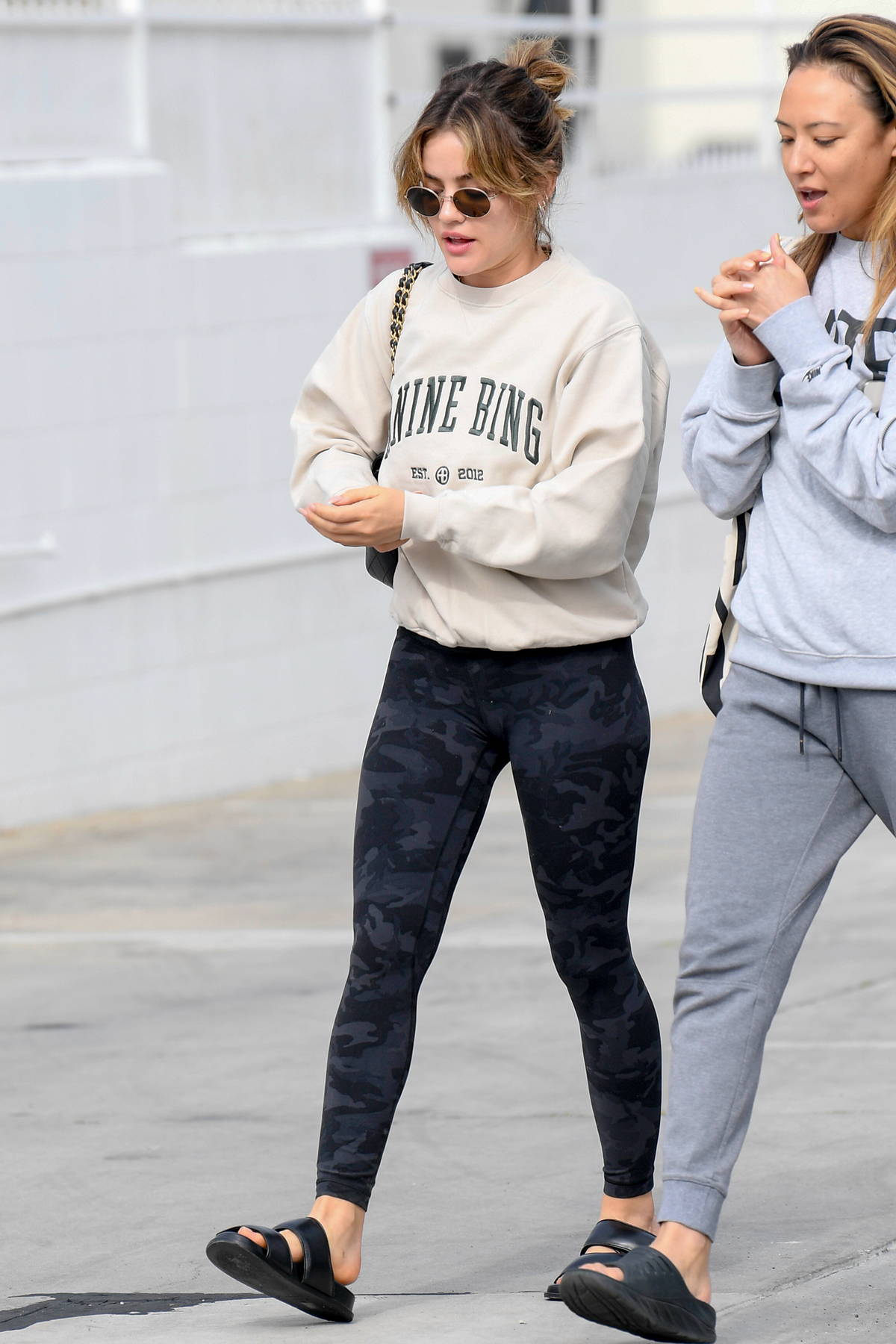 Lucy Hale sports a sweatshirt with black camo leggings while
