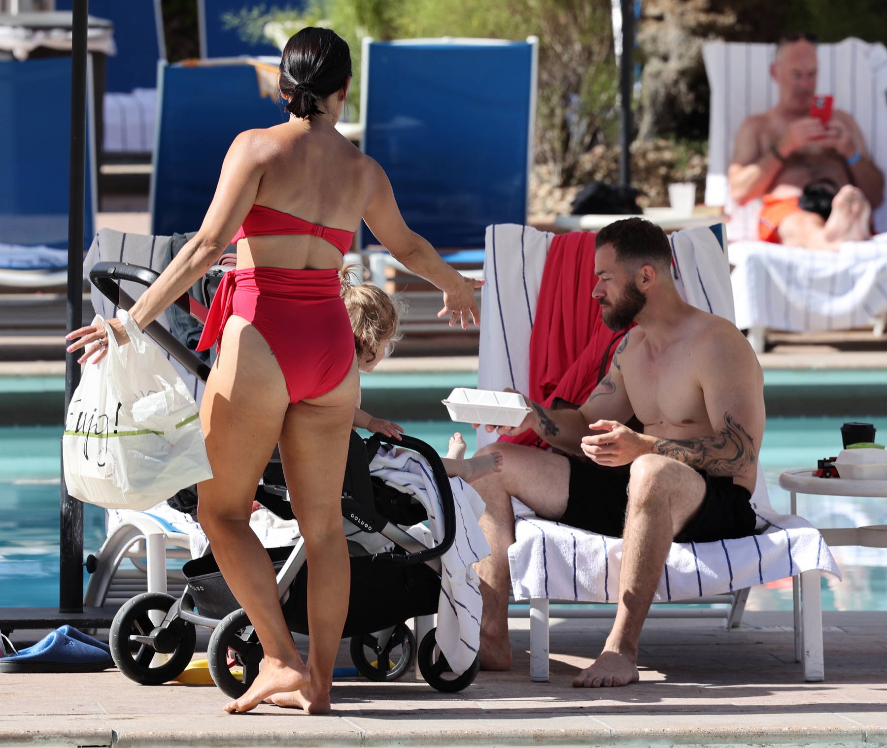 Nikki Bella slips into a red bikini while enjoying some downtime with Artem  Chigvintsev and their