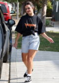 Addison Rae is all smiles out wearing a black tee and denim cut-offs in West Hollywood, California