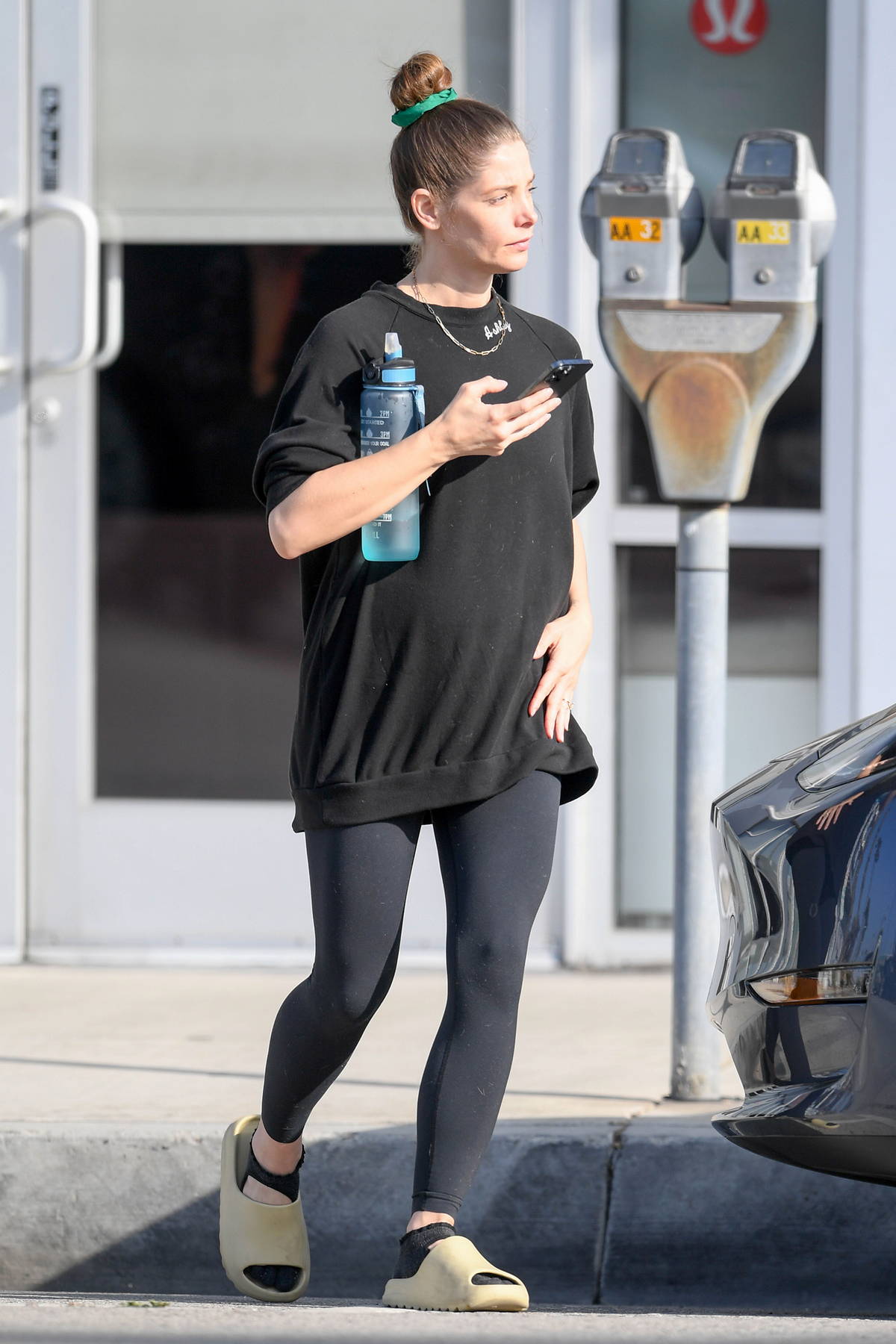 Ashley Greene shows her baby bump in an oversized t-shirt and