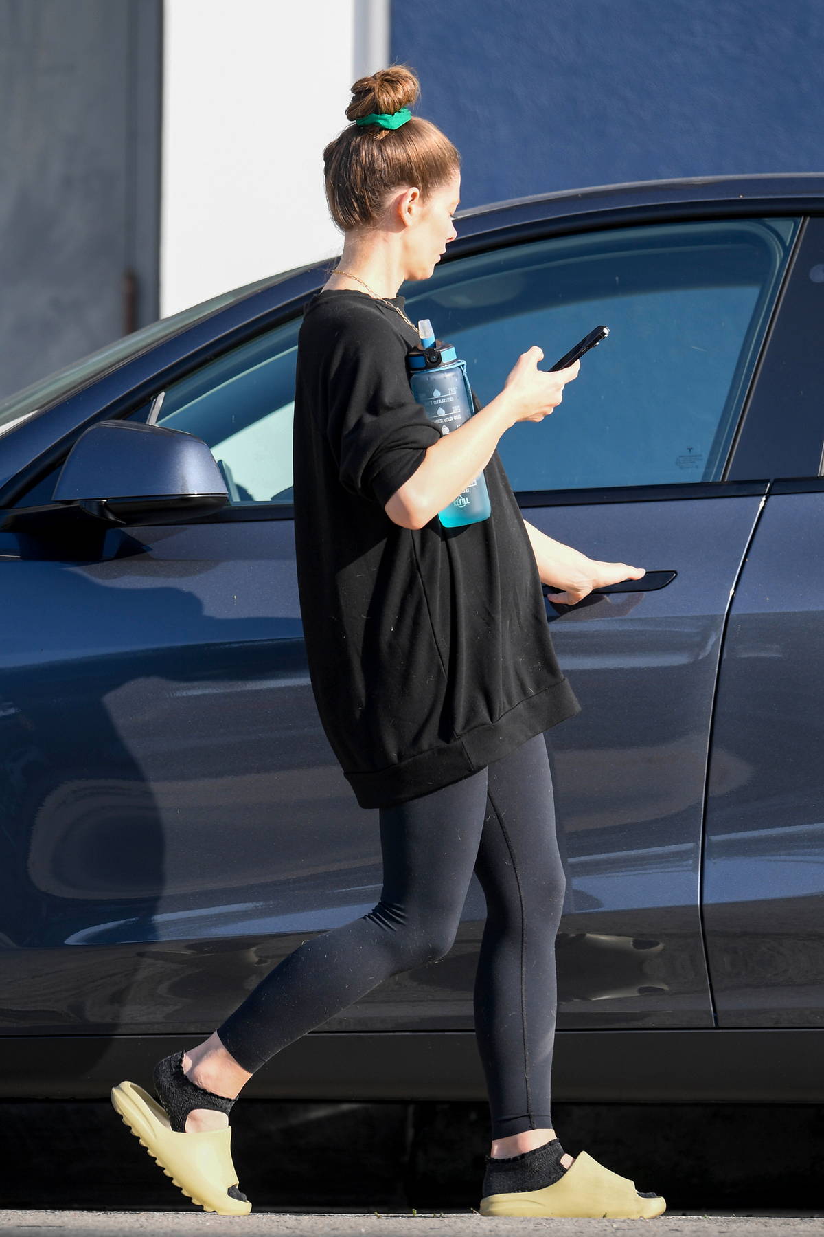 Ashley Greene shows her baby bump in an oversized t-shirt and leggings as  she hits