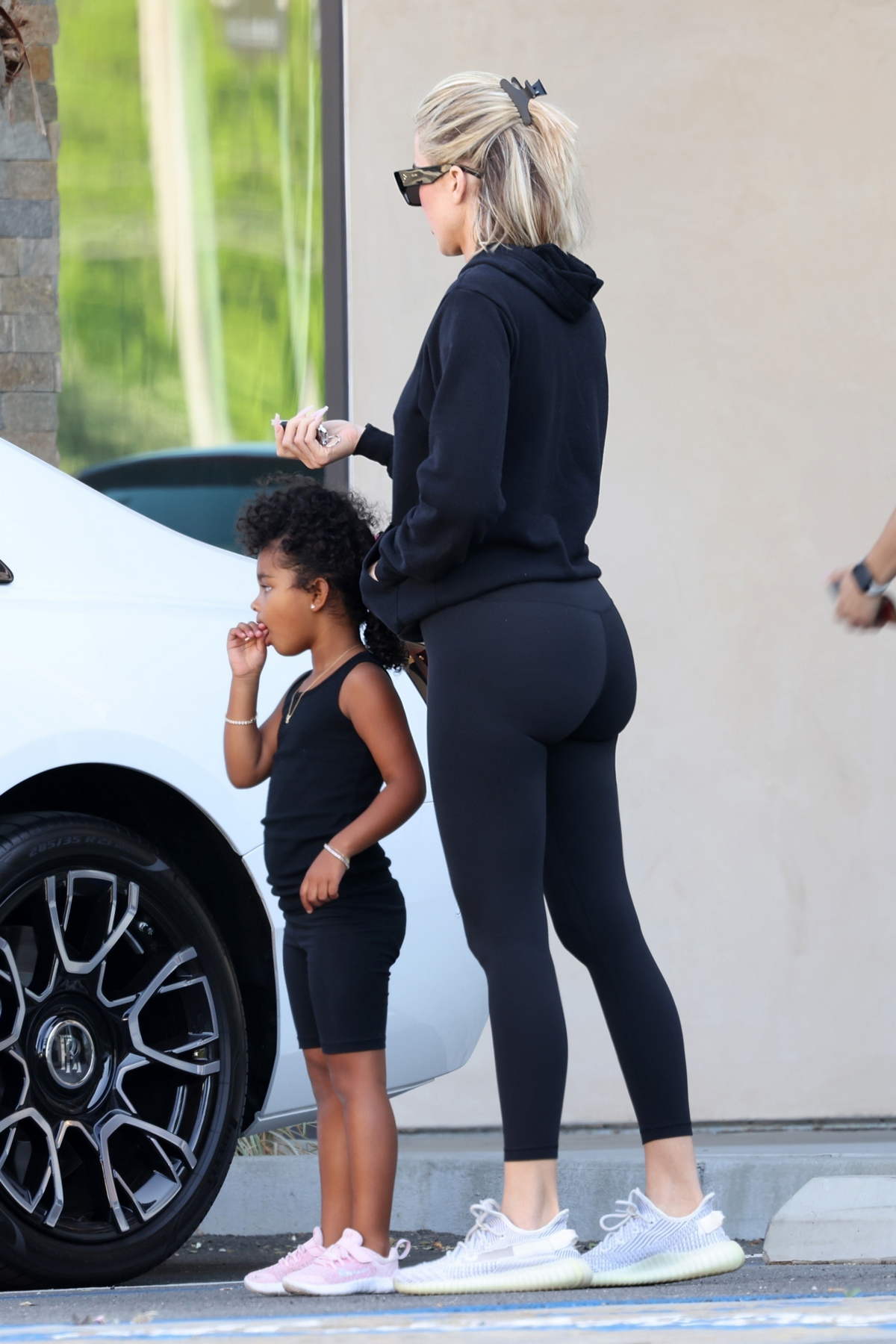 https://www.celebsfirst.com/wp-content/uploads/2022/05/khloe-kardashian-sports-a-black-hoodie-and-leggings-as-she-takes-daughter-to-gymnastics-class-in-los-angeles-040522_1.jpg