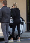 Khloe Kardashian sports a black hoodie and leggings as she takes