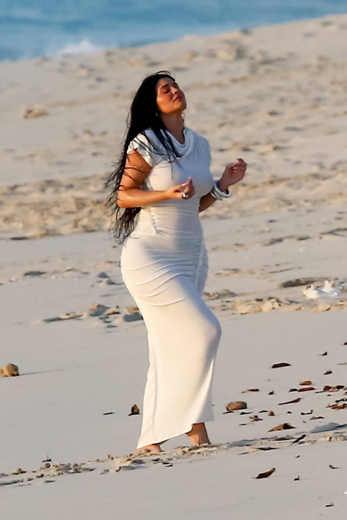 Kylie Jenner flaunts her curves in a skintight white dress teamed