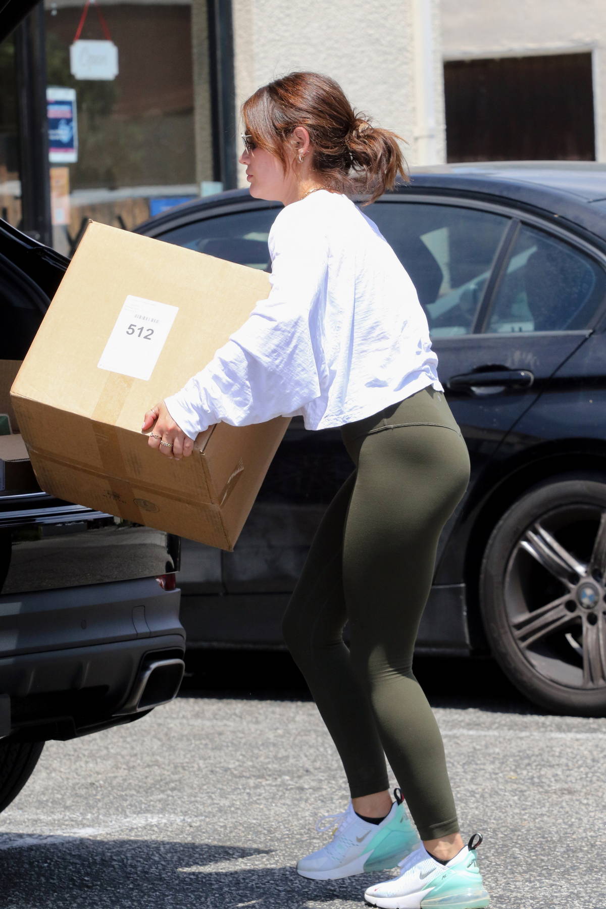 Lucy Hale wears sweatshirt and dark grey leggings as she grabs a coffee and  enjoys a