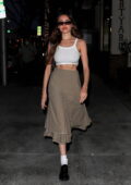 Madison Beer shows off her toned abs in a cropped white tank top and khaki skirt while out for dinner in Beverly Hills, California