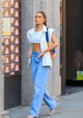 Olivia Culpo flashes her toned abs in a white crop top while out on a stroll in London, UK