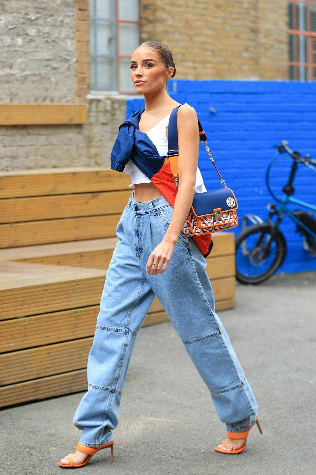 Olivia trendy in a crop top and baggy jeans while out in London,