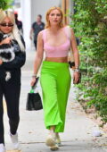 Bella Thorne looks pretty in a pink top paired with neon green pants while  stepping out