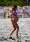 Camila Coelho bares her growing baby bump in a purple bikini at