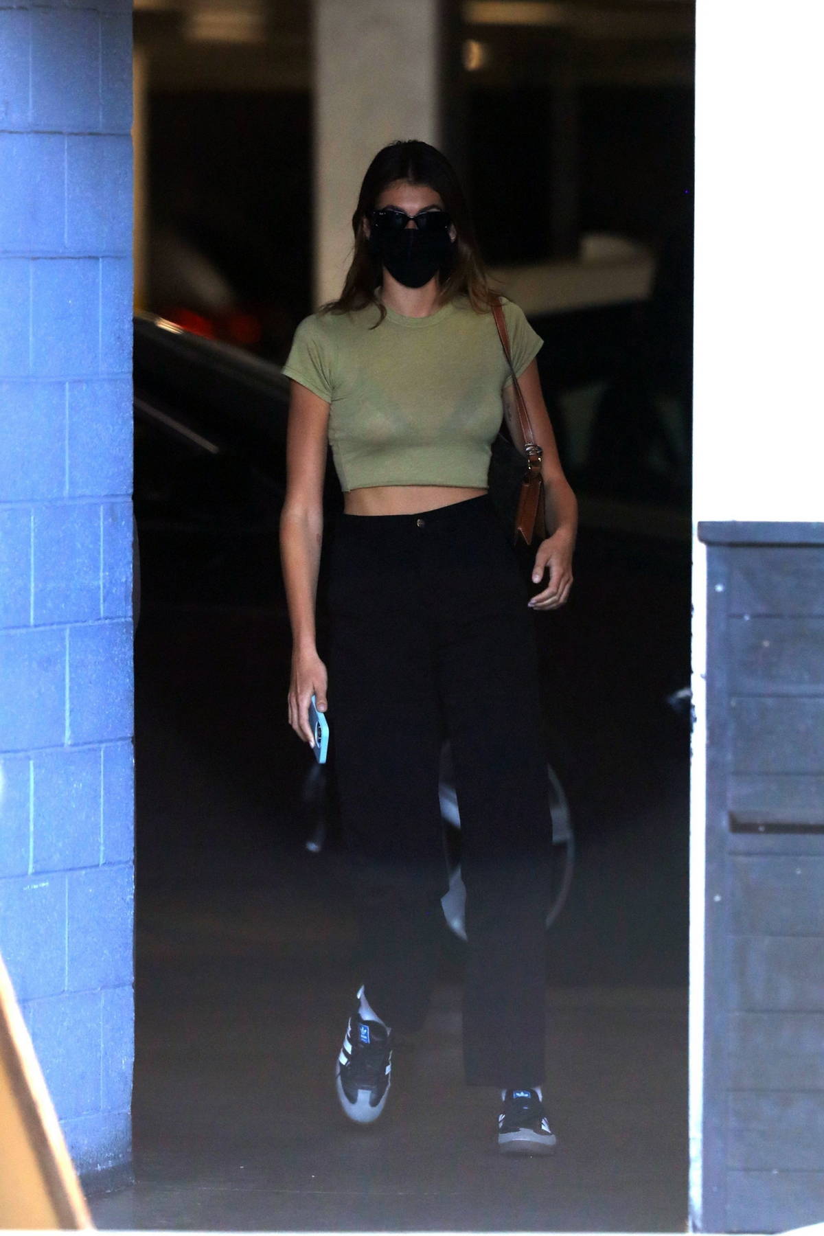 Ariel Winter sports hot pink leggings and a sheer top for a trip