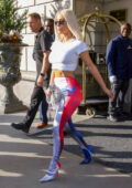 Kim Kardashian shows off her famous curves in a white crop top and Balenciaga  leggings while
