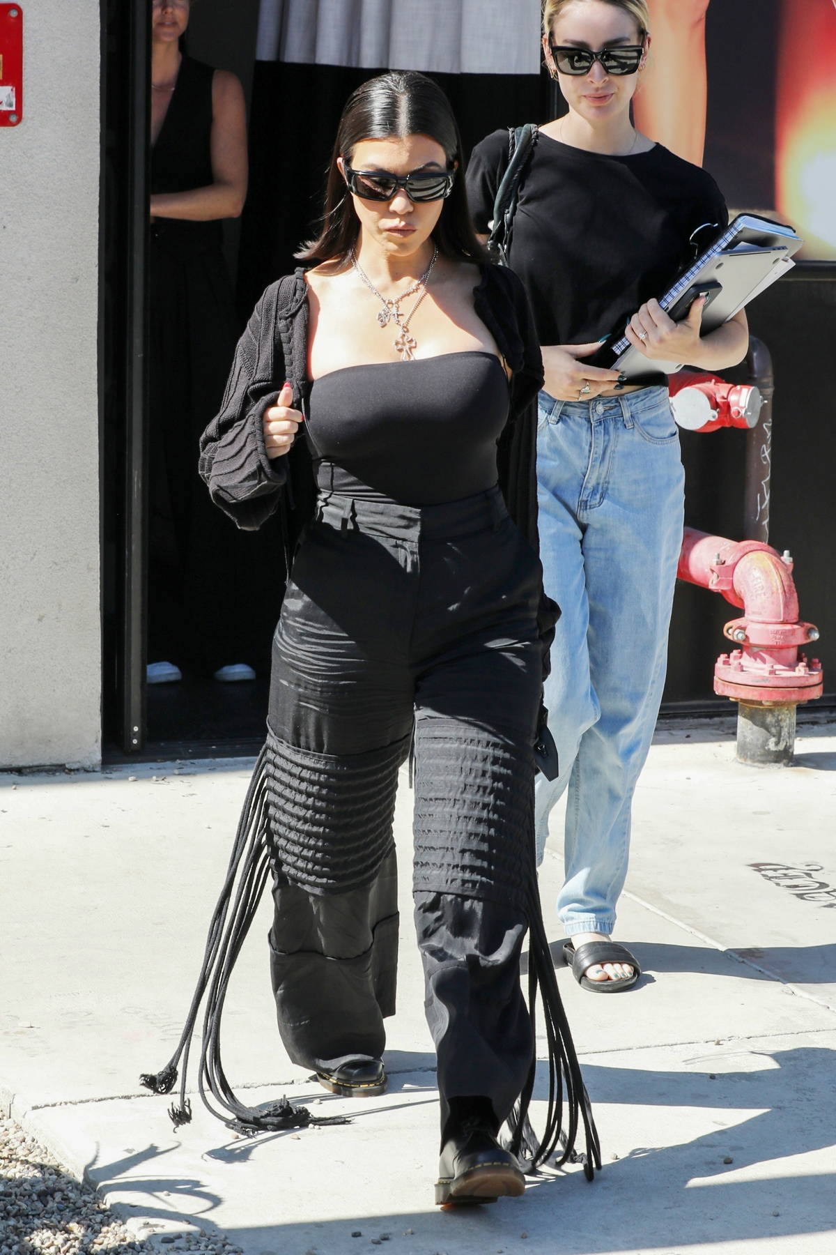 Kourtney Kardashian dons all-black as she leaves after a photoshoot at the  BooHoo store in