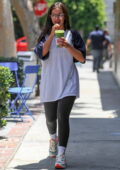Addison Rae wears an oversized t-shirt and leggings while grabbing a green smoothie at Alfred Tea Room in West Hollywood, California