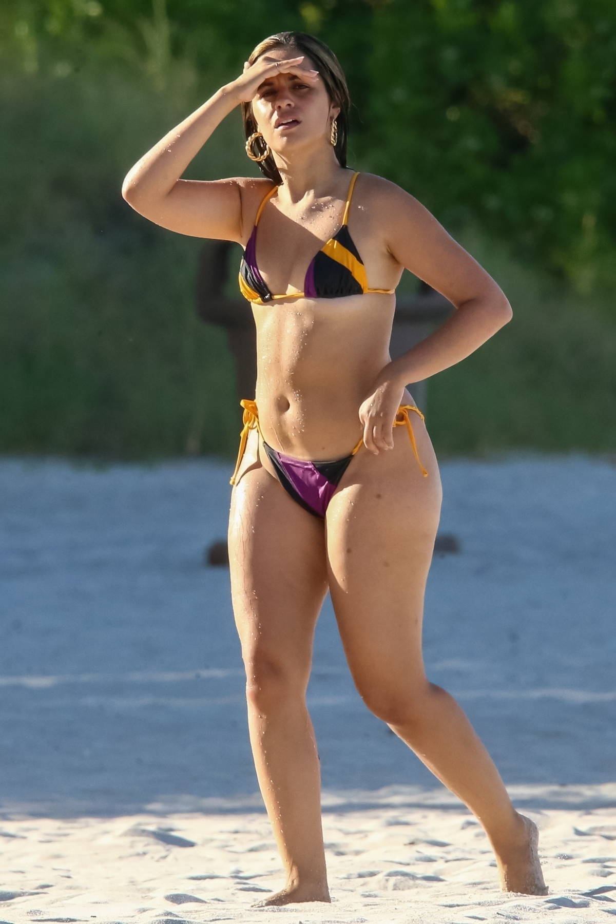 Camila Cabello shows off her beach body in a string bikini as she goes for  swim