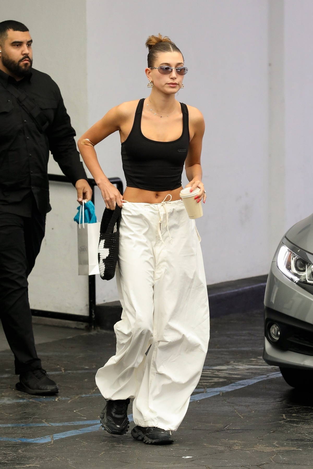 Hailey Bieber displays her svelte figure in crop top and baggy pants ...