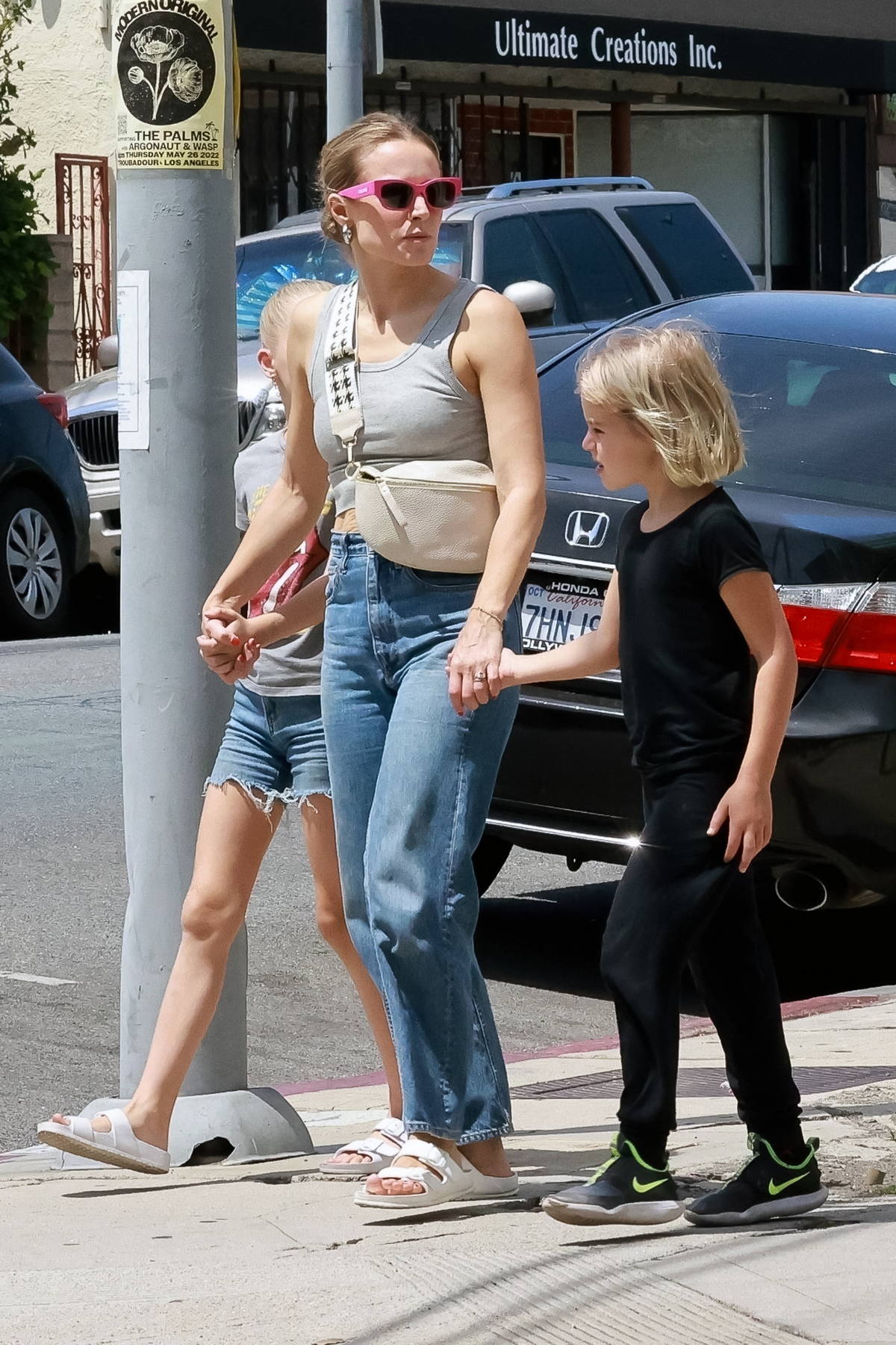 kristen bell wears a grey crop top and jeans while out to grab