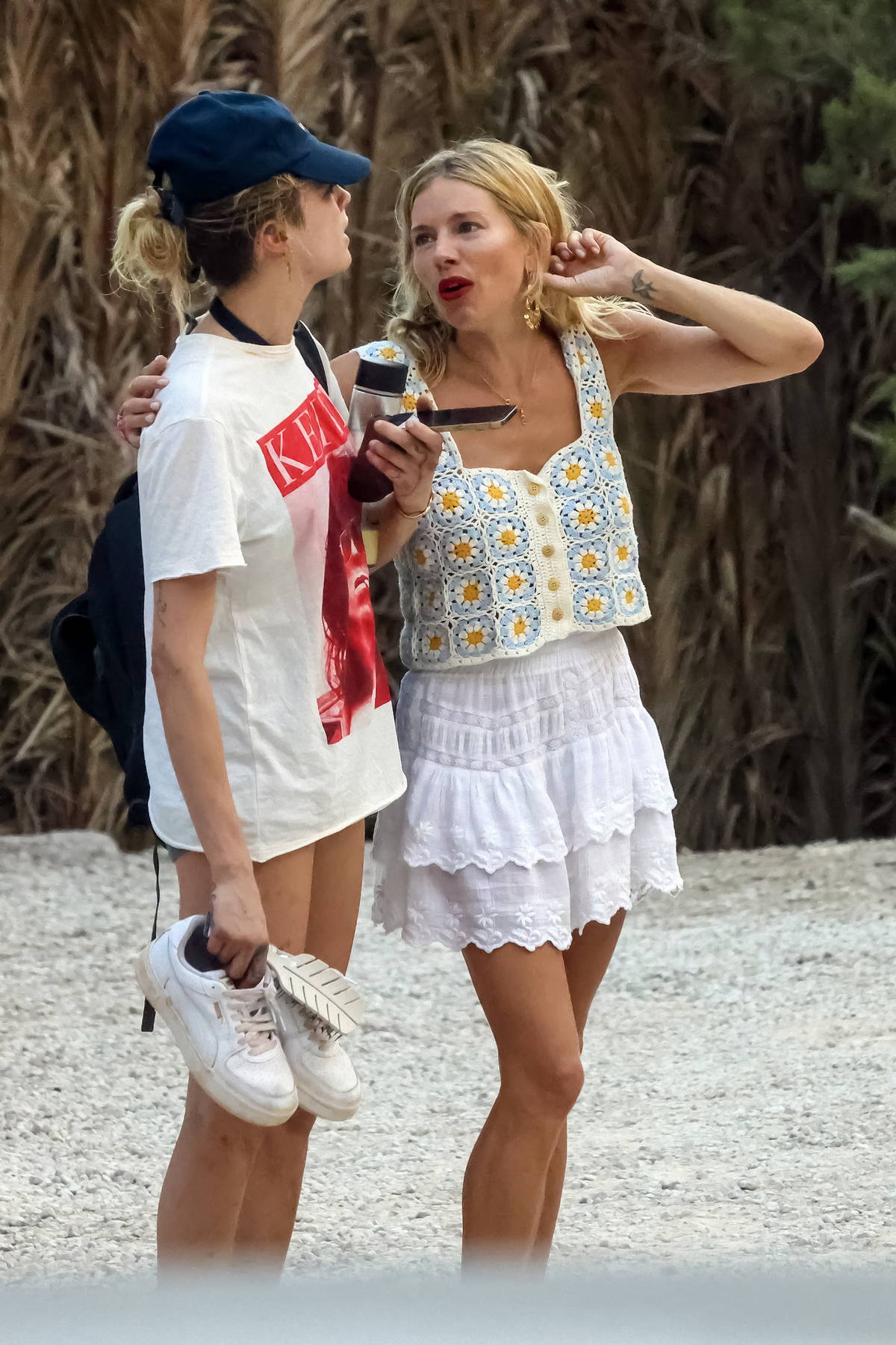 Cara Delevingne and Sienna Miller get leggy as they hit the beach with friends while vacationing in Ibiza, Spain