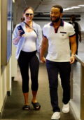 Chrissy Teigen shows off her baby bump in a white top while visiting an office building with John Legend in Beverly Hills, California