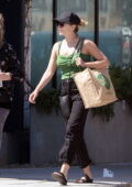 Elizabeth Olsen wears green top and black jeans while shopping groceries at Whole Foods in Los Angeles