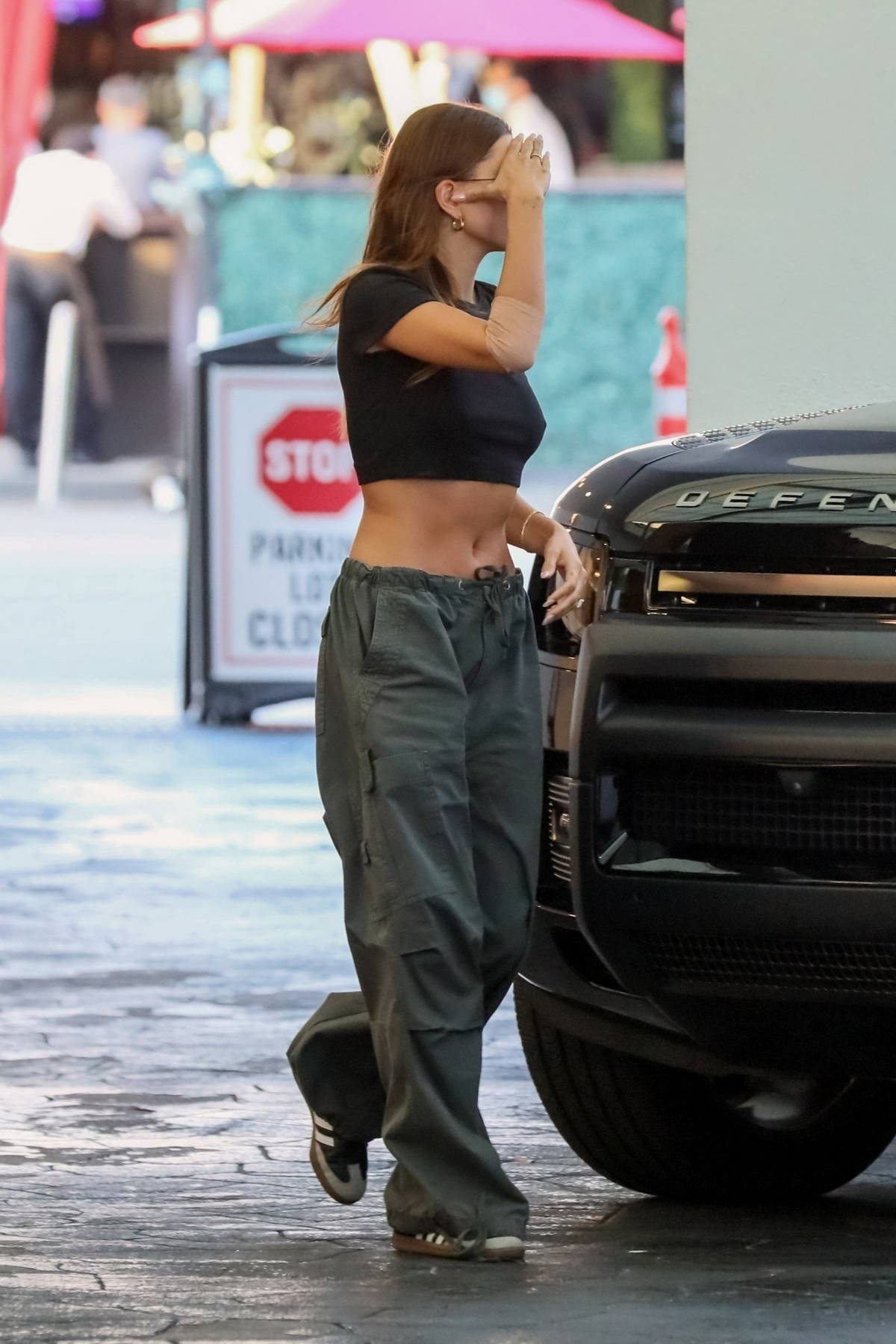 Hailey Bieber gives a hint of midriff in crop top and flared pants