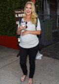 Heidi Montag cradles her baby bump as she leaves after dinner at Giorgio Baldi in Santa Monica, California