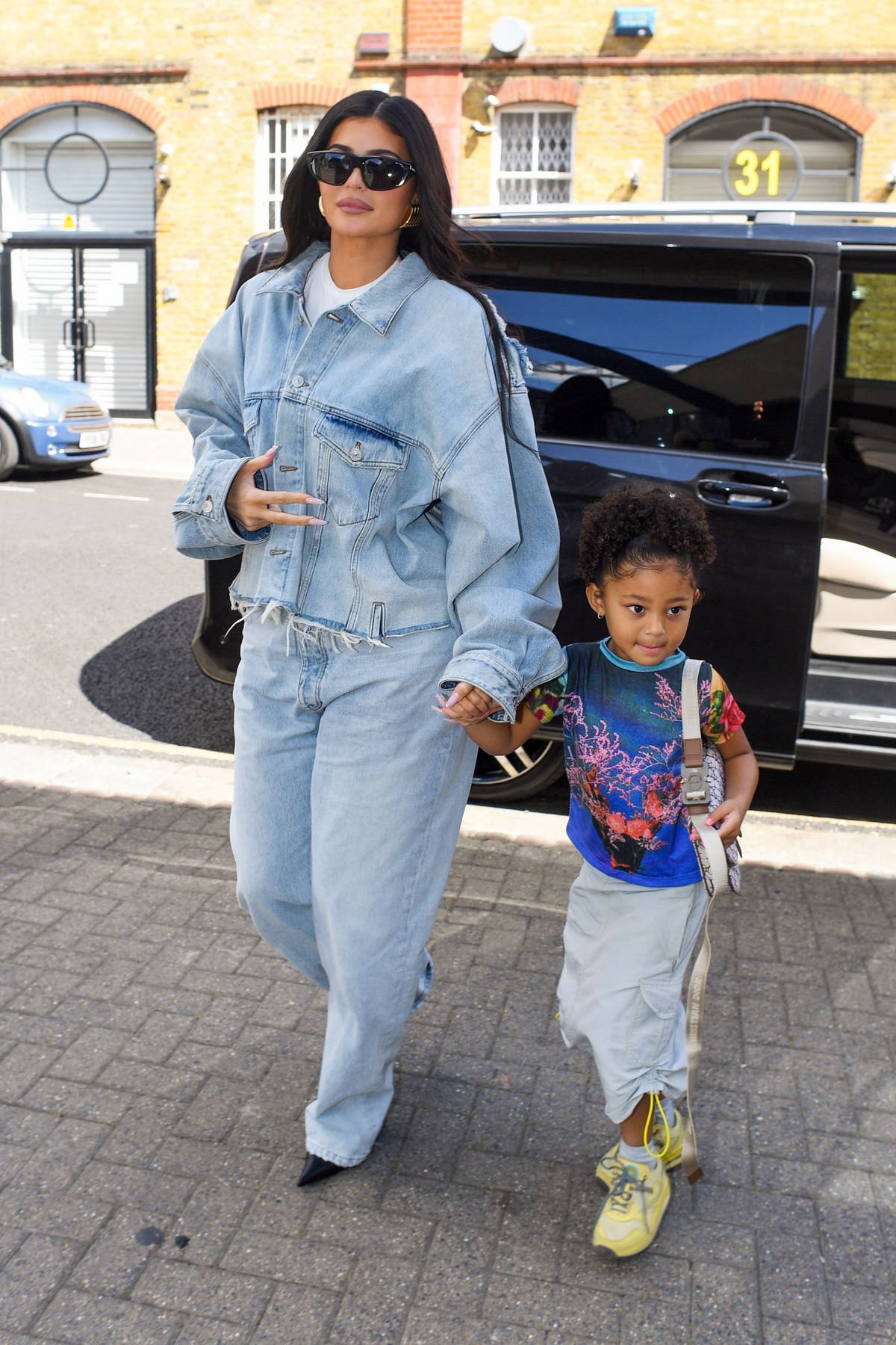 Kylie Jenner dons double denim as she arrives at a studio with her ...