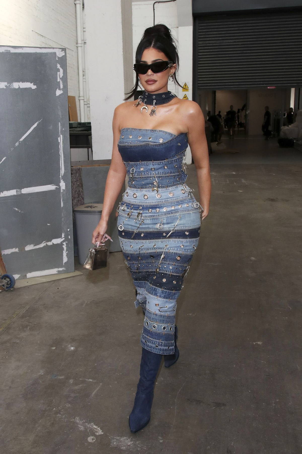 Kylie Jenner looks fashionable in a bodycon denim dress as she arrives ...