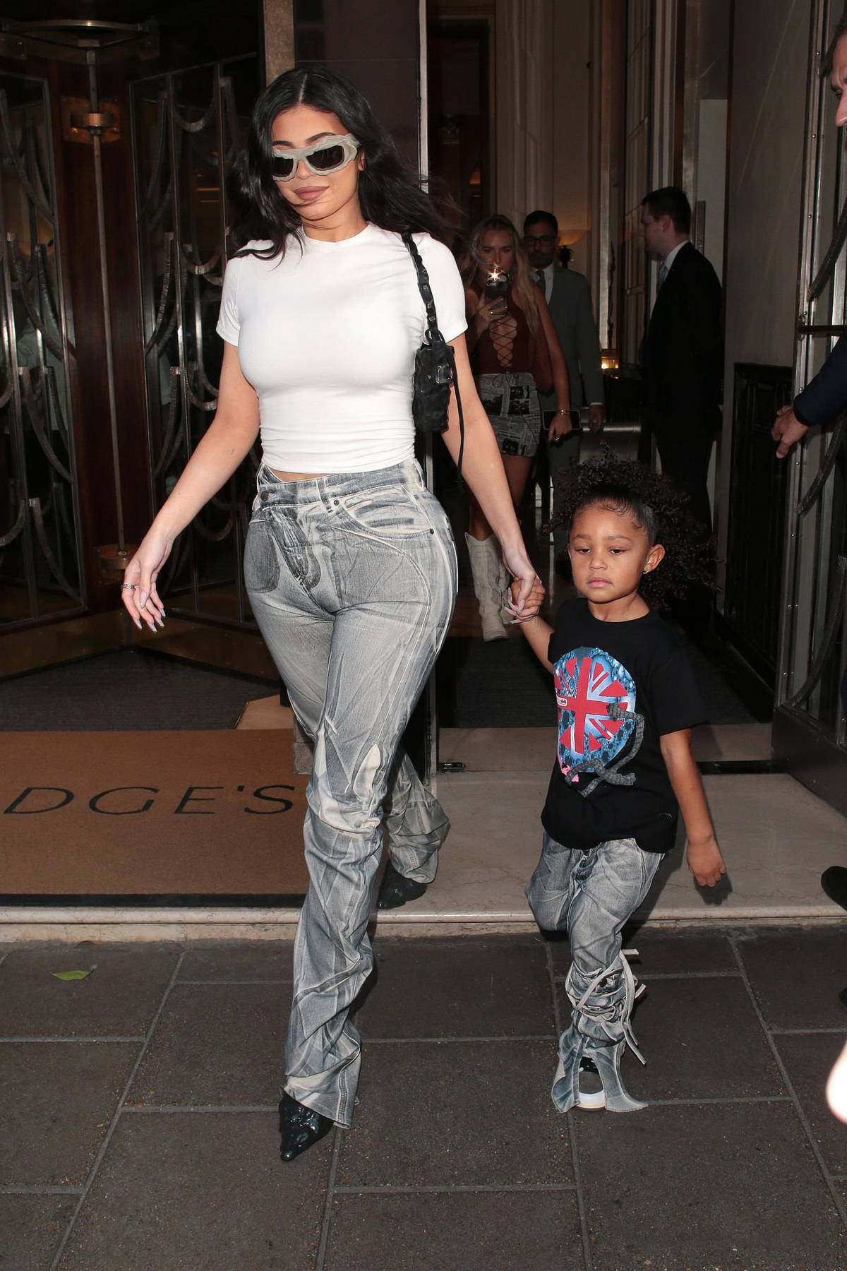 Kylie Jenner rocks a white skintight top and grey jeans while heading out  with her daughter