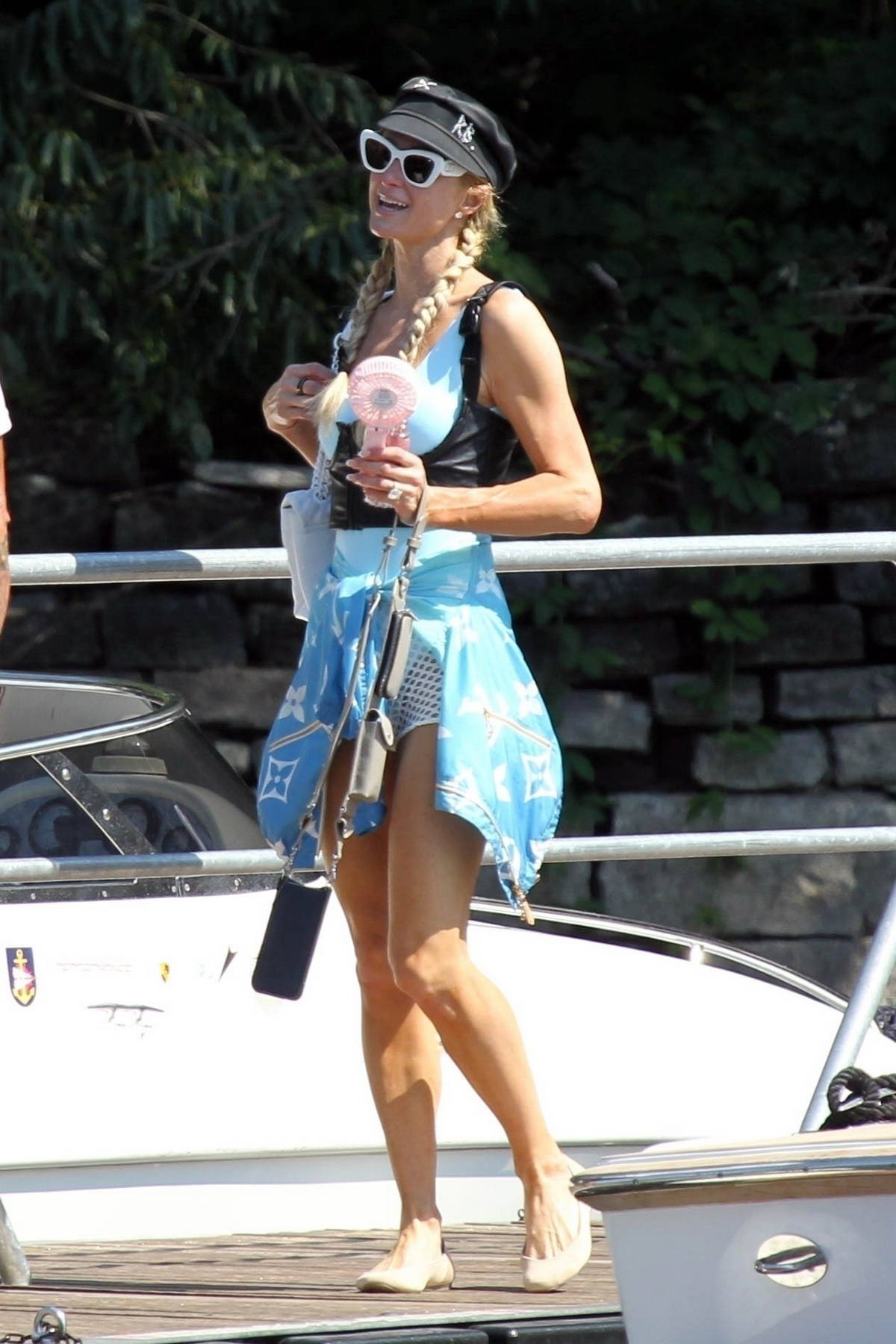 paris hilton looks stylish in a blue louis vuitton sarong while enjoying  her summer holiday with husband carter reum in lake como, italy-040822_8