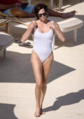 Charlize Theron slips into a white swimsuit while enjoying the sun at the beach in Tuscany, Italy