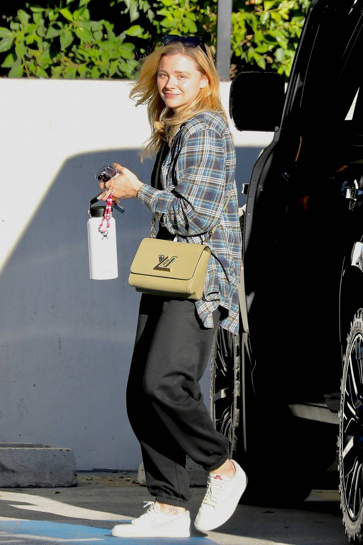 Chloe Grace Moretz is all smiles while running errands wearing a plaid ...