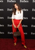 Emily Ratajkowski looks amazing in a bright pants and gold pumps while attending Forbes Power Women's Summit in New York City