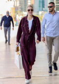 Gigi Hadid is all smiles while out wearing a burgundy jumpsuit during Milan Fashion Week in Milan, Italy