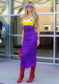 Heidi Klum dons yellow and purple Puma dress with red boots as she arrives for AGT taping in Pasadena, California